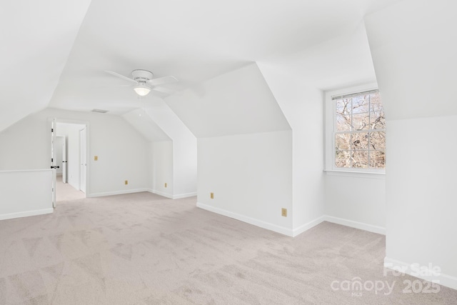 additional living space with lofted ceiling, carpet, baseboards, and ceiling fan