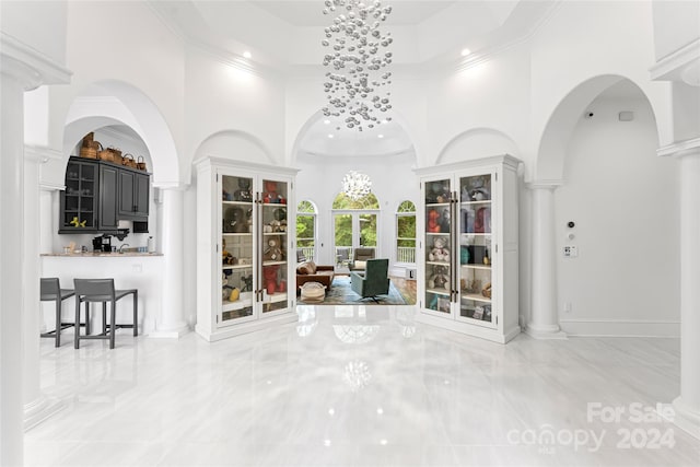 interior space with decorative columns and a high ceiling