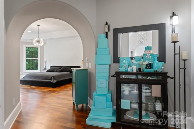 bedroom featuring hardwood / wood-style flooring and a chandelier