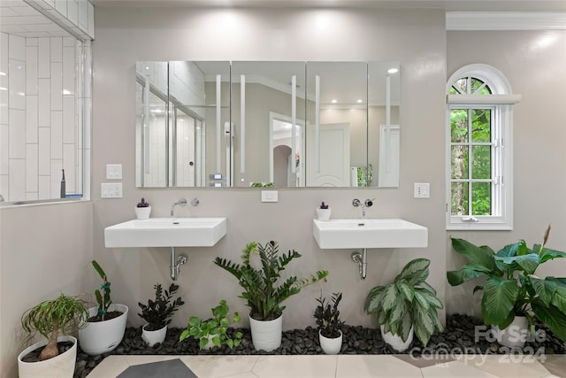 bathroom with crown molding, sink, and tile patterned flooring