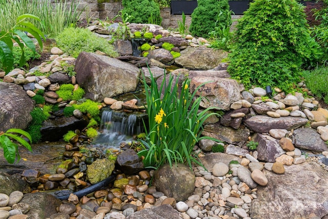 exterior details with a small pond