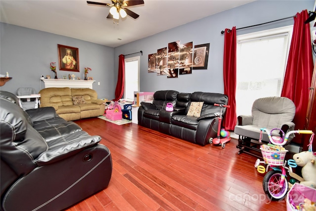 living room featuring ceiling fan and hardwood / wood-style flooring