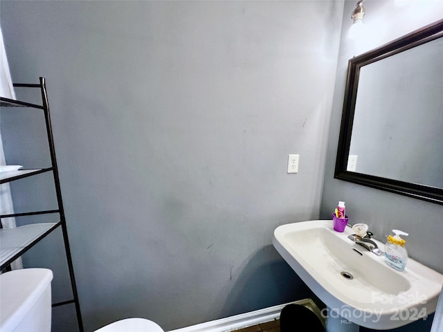 bathroom featuring sink and toilet