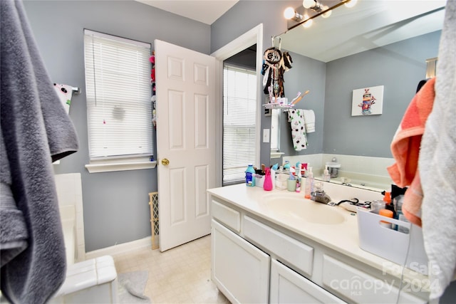 bathroom with vanity, a chandelier, and tile floors