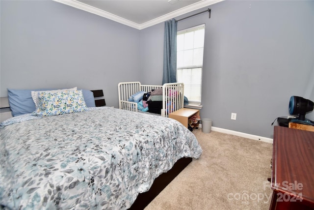 bedroom featuring ornamental molding and carpet floors