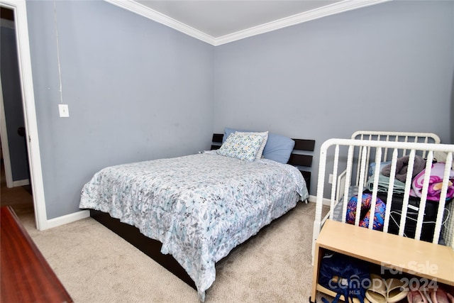 bedroom with crown molding and carpet