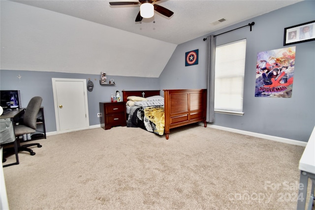 carpeted bedroom featuring vaulted ceiling, ceiling fan, and a textured ceiling