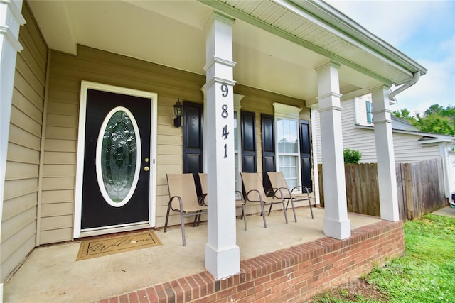 view of exterior entry with covered porch