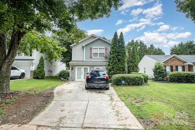 view of front of home featuring a front yard and a garage