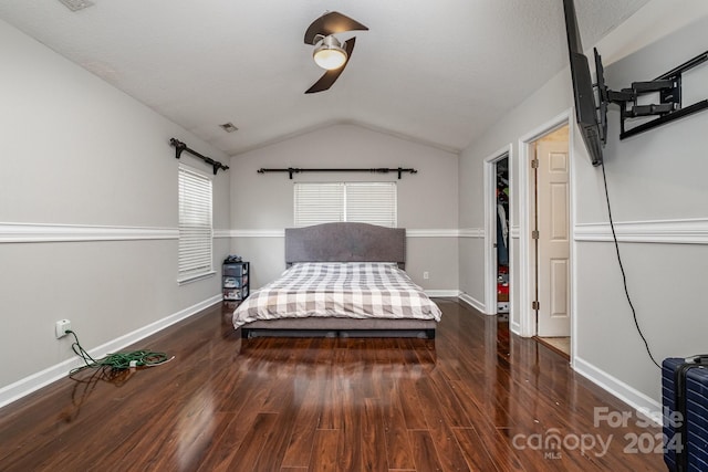 unfurnished bedroom featuring dark hardwood / wood-style flooring, ceiling fan, and lofted ceiling