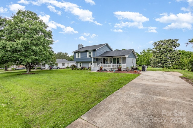 view of front facade with covered porch and a front yard