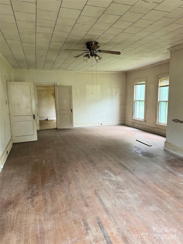 unfurnished bedroom with ceiling fan and dark hardwood / wood-style flooring