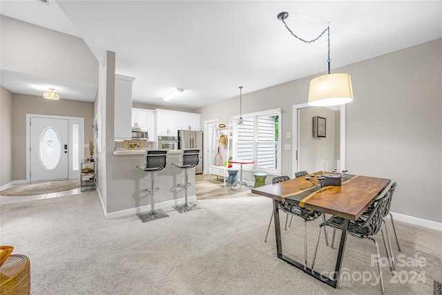 dining room featuring light carpet