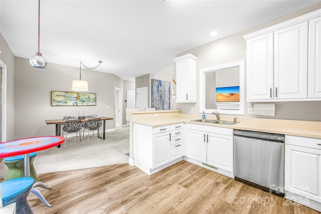 kitchen with pendant lighting, white cabinetry, sink, stainless steel dishwasher, and kitchen peninsula