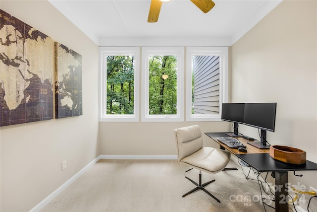 carpeted office space featuring ceiling fan