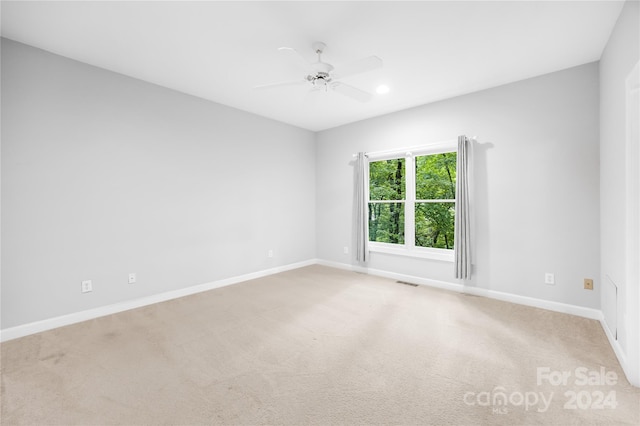 carpeted empty room with ceiling fan