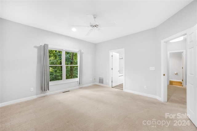 carpeted empty room with ceiling fan