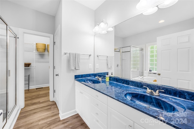 bathroom featuring vanity, a shower with shower door, and hardwood / wood-style floors