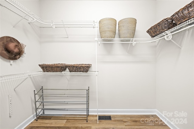 spacious closet featuring hardwood / wood-style flooring