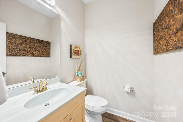 bathroom with vanity, wood-type flooring, and toilet