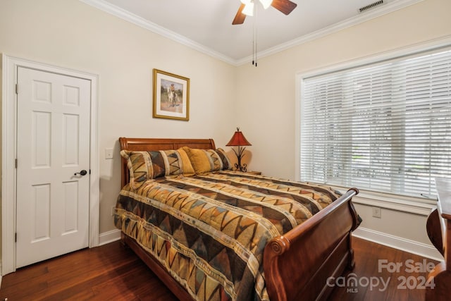 bedroom featuring dark hardwood / wood-style flooring, ornamental molding, and ceiling fan