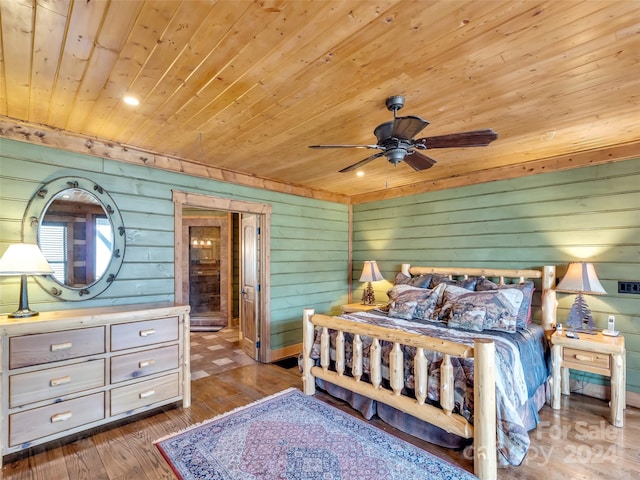 bedroom with wooden walls, ceiling fan, hardwood / wood-style flooring, and wooden ceiling