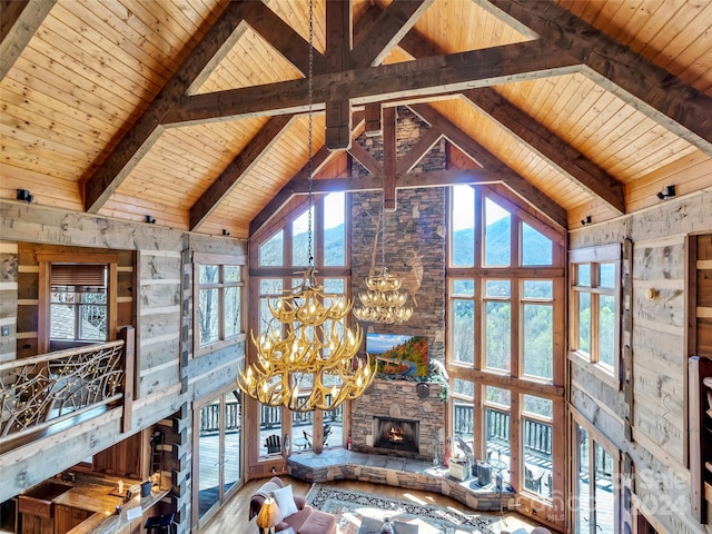 unfurnished living room featuring wooden ceiling, a stone fireplace, and beam ceiling