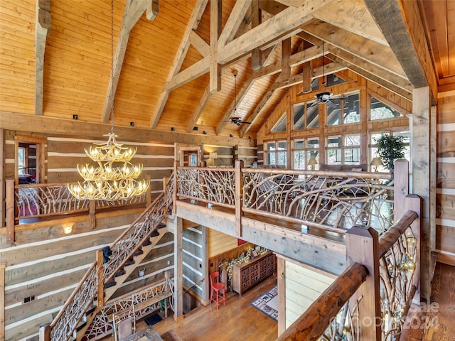 interior space with hardwood / wood-style flooring, beam ceiling, a notable chandelier, high vaulted ceiling, and wood ceiling