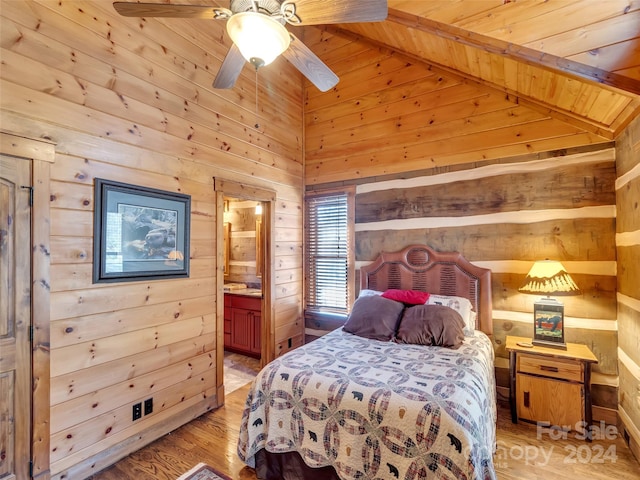 bedroom with light hardwood / wood-style floors, lofted ceiling with beams, wood ceiling, ensuite bathroom, and ceiling fan