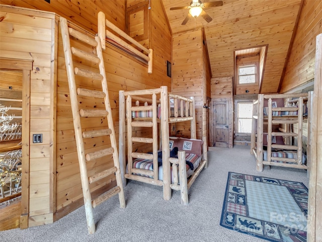 unfurnished bedroom with carpet, high vaulted ceiling, wooden walls, and wood ceiling