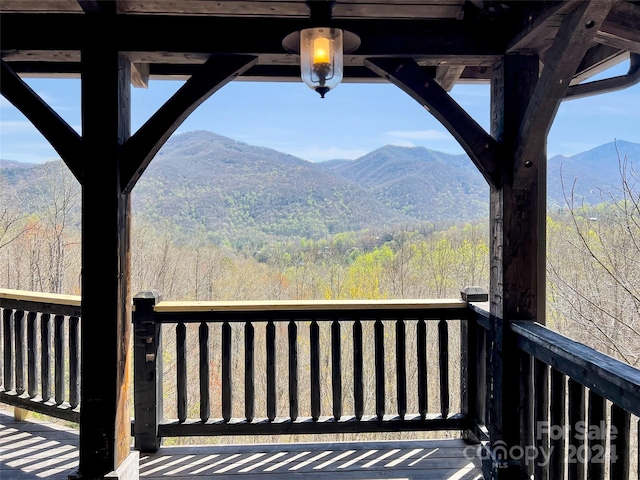 wooden deck with a mountain view