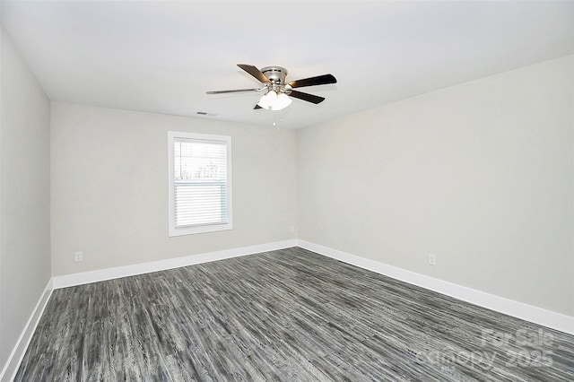 empty room featuring dark hardwood / wood-style flooring and ceiling fan