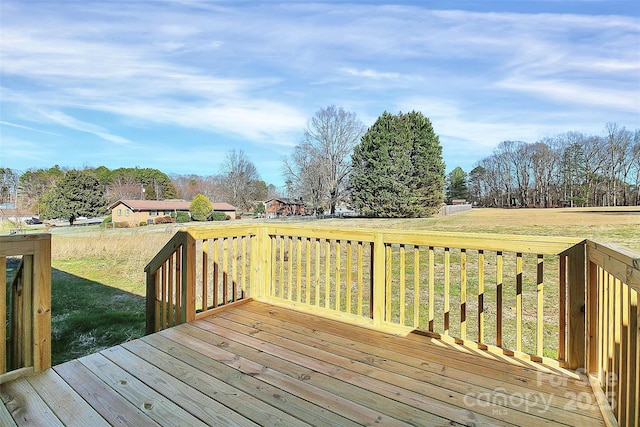 wooden terrace featuring a lawn