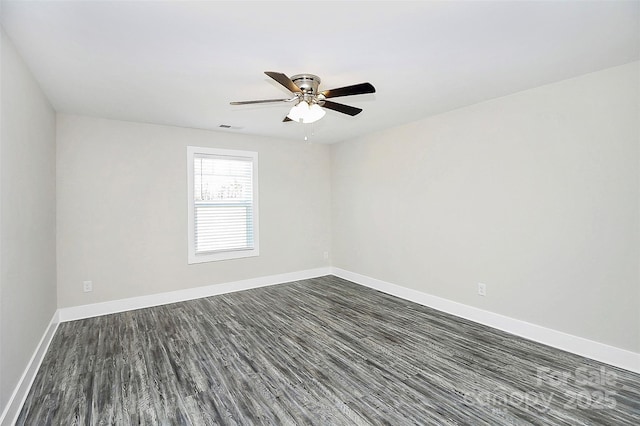 unfurnished room with ceiling fan, baseboards, dark wood-style flooring, and visible vents