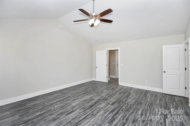 unfurnished bedroom with dark wood-type flooring, vaulted ceiling, a ceiling fan, and baseboards