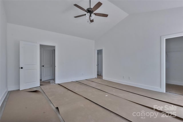 unfurnished bedroom featuring high vaulted ceiling, a closet, baseboards, and ceiling fan