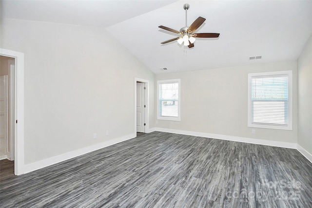 empty room featuring visible vents, a wealth of natural light, ceiling fan, and dark wood finished floors