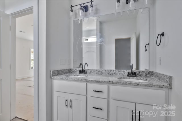 bathroom with plenty of natural light, a sink, and double vanity