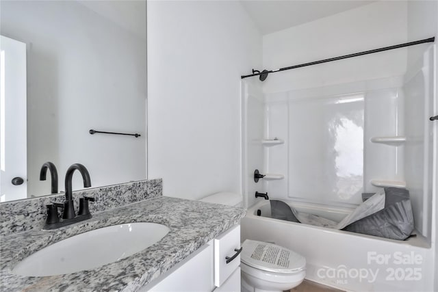 full bathroom with toilet, vanity, and  shower combination