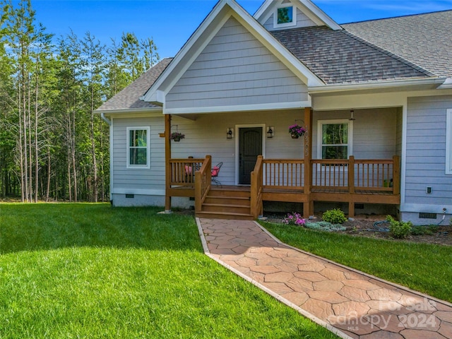 view of front of house featuring a front yard and covered porch