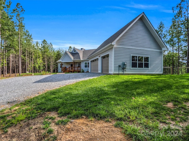 view of front of home with a front yard and a garage