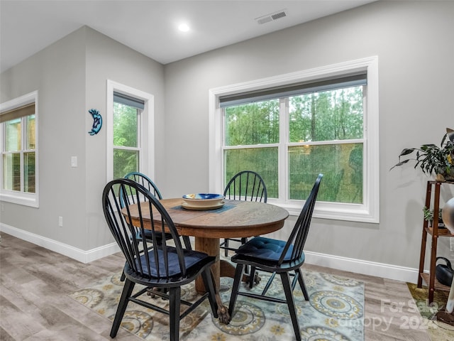 dining space with a wealth of natural light and hardwood / wood-style floors