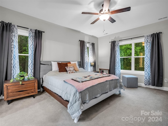 bedroom with light carpet and ceiling fan