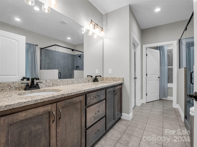 bathroom with dual vanity and tile flooring