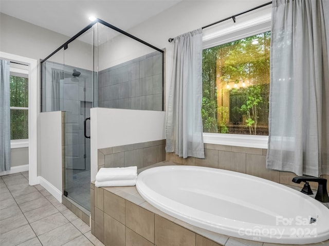 bathroom featuring tile floors and plus walk in shower