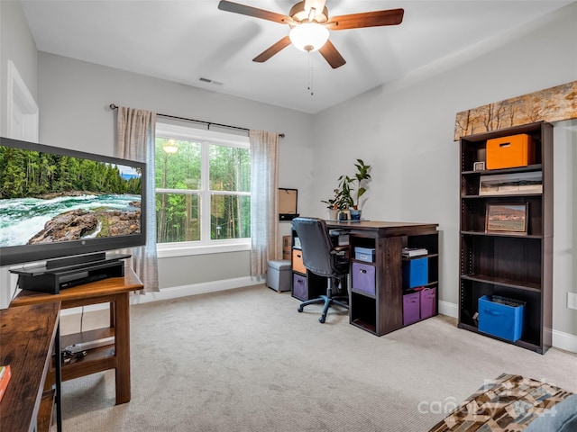 carpeted office featuring ceiling fan