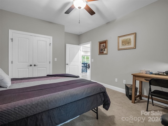 carpeted bedroom with ceiling fan and a closet