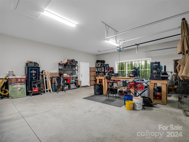 garage with a workshop area and a garage door opener