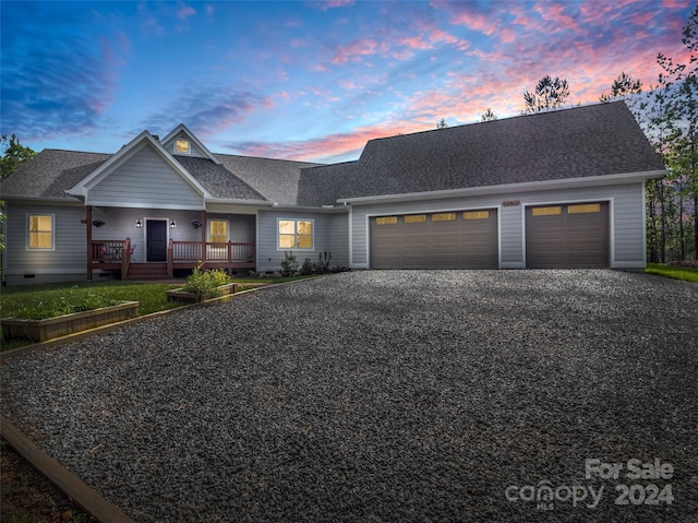 view of front of house featuring a garage and a porch