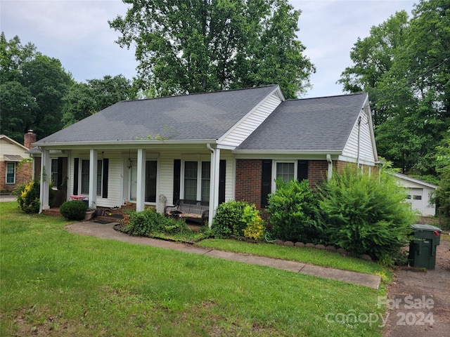 view of front of home featuring a front yard and a porch